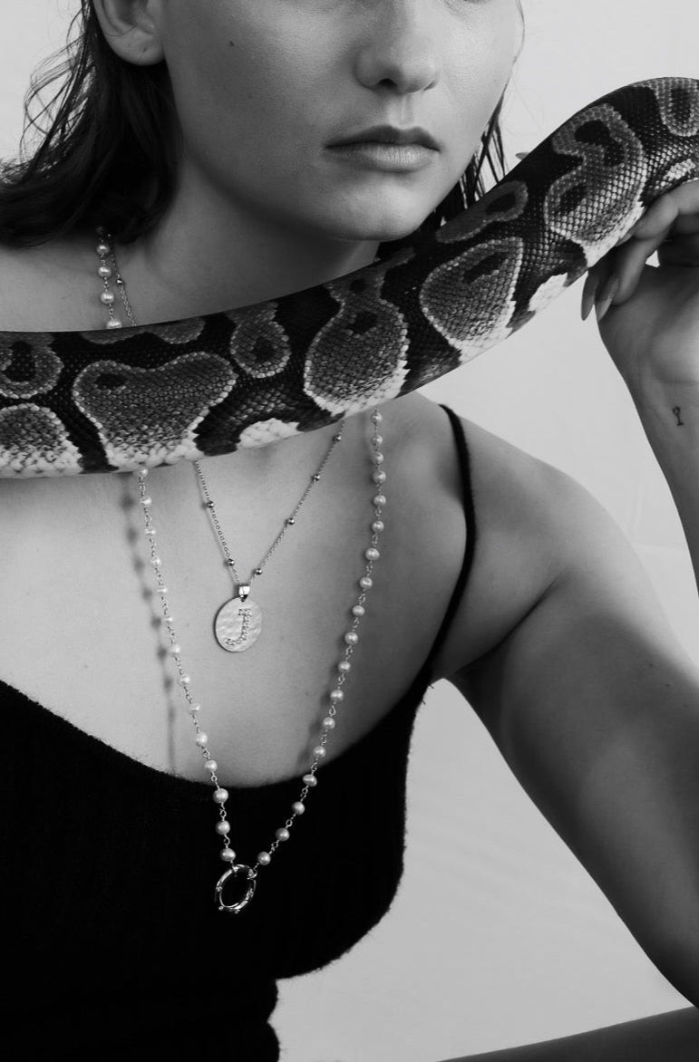 Black and white photo of a woman holding a snake