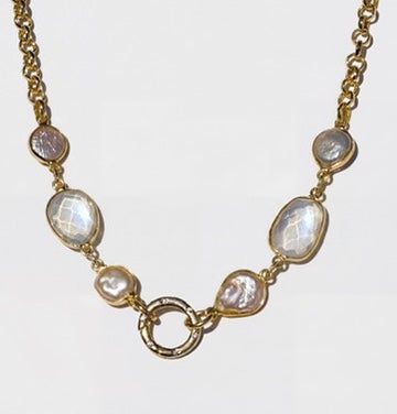 IRIS gold necklace showing moonstone and pearl stations beside the front lock clasp.