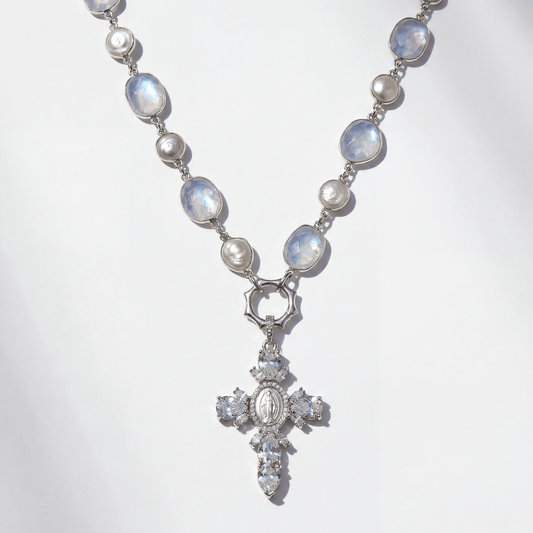 Necklace with moonstone and pearl beads and a cross pendant on a white background
