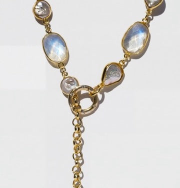 Close-up of the IRIS gold moonstone and pearl necklace front clasp in a lariat arrangement.