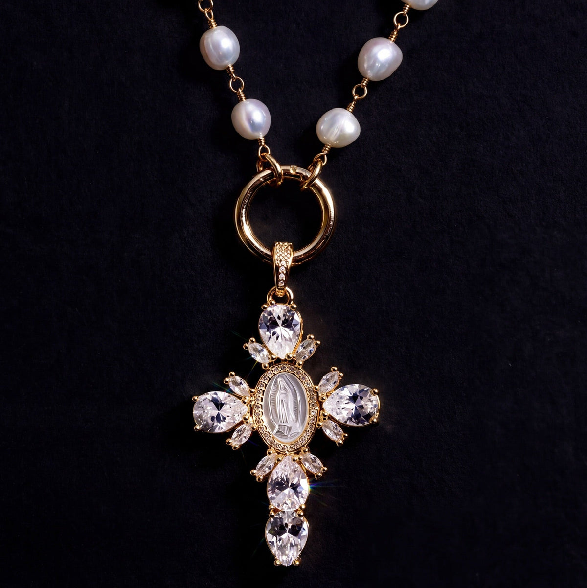 Gold Pearl Cross Necklace with freshwater pearls and crystal cross pendant on a black background.
