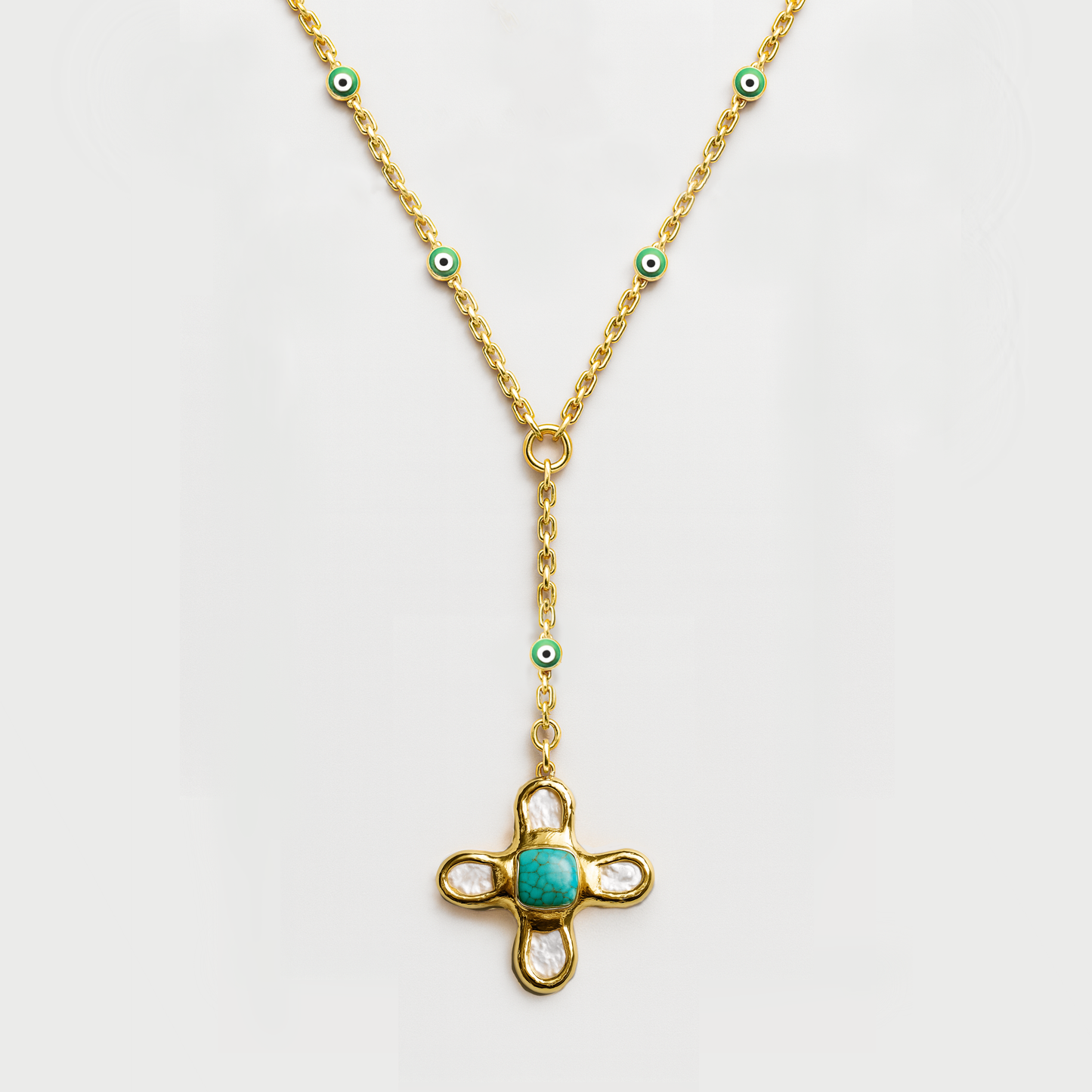 Gold necklace with a turquoise pendant on a white background