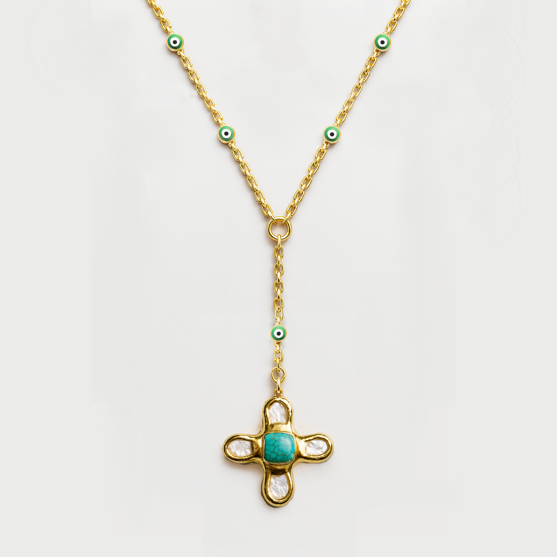Gold necklace with a turquoise pendant on a white background