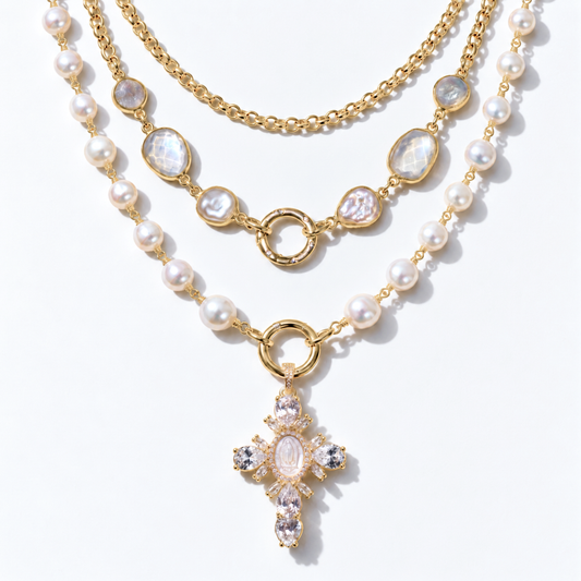Gold pearl cross moonstone layering set arranged in three visible rows with two front clasps.