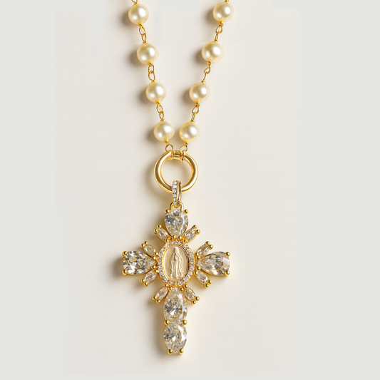 Pearl necklace with a gold cross pendant on a light gray background