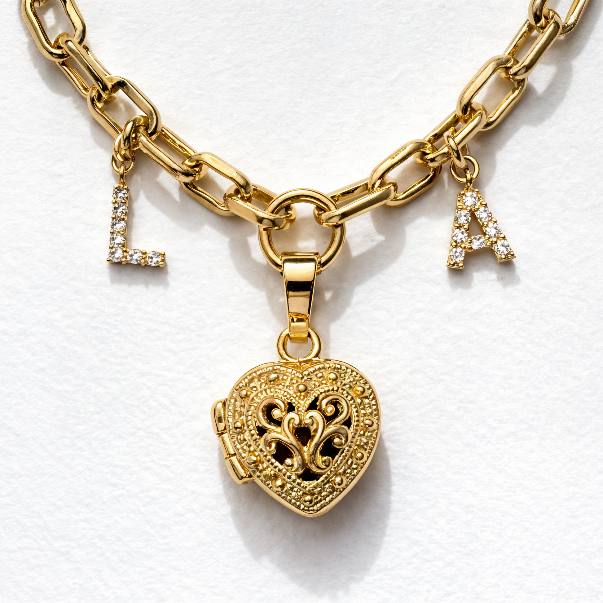 Gold chain bracelet with heart-shaped lock charm on a white background